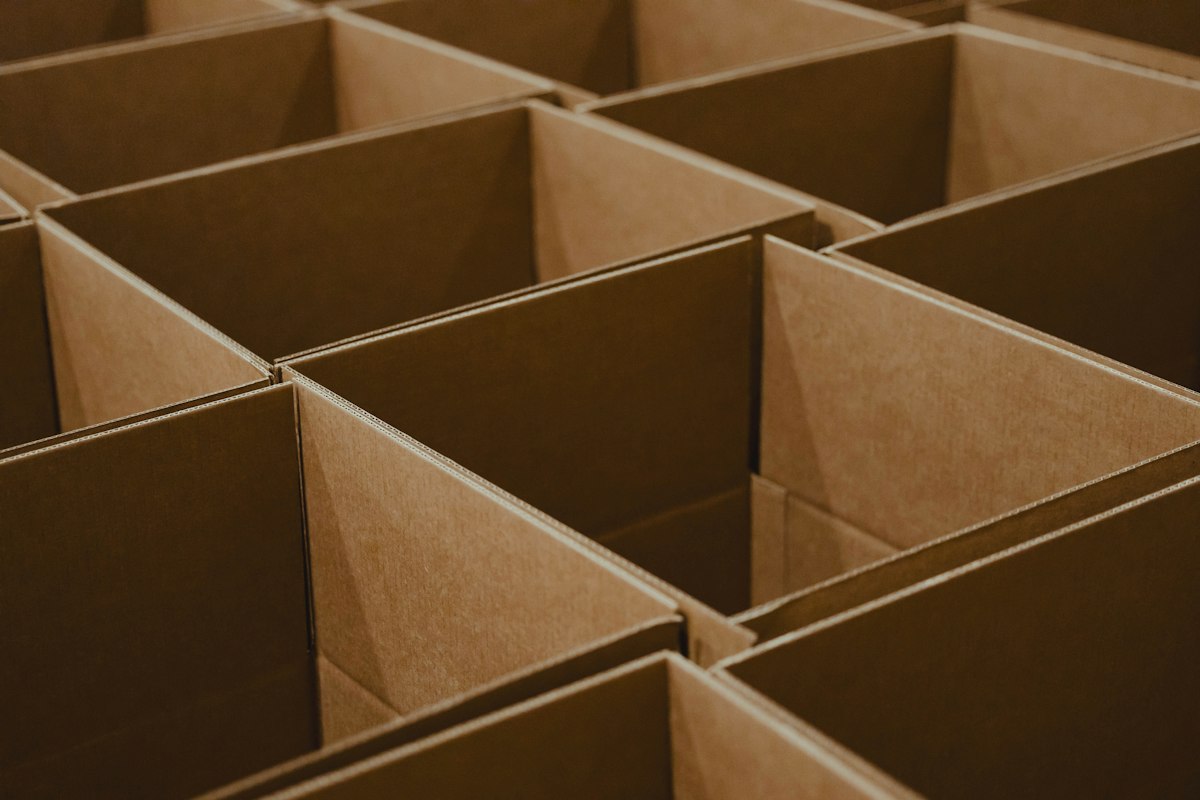 Open corrugated shipping boxes prepared for protective packing